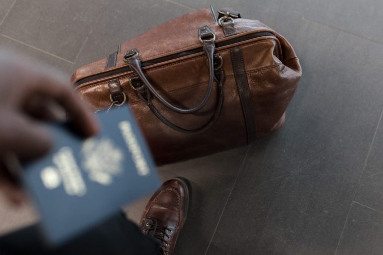 person holding their passport