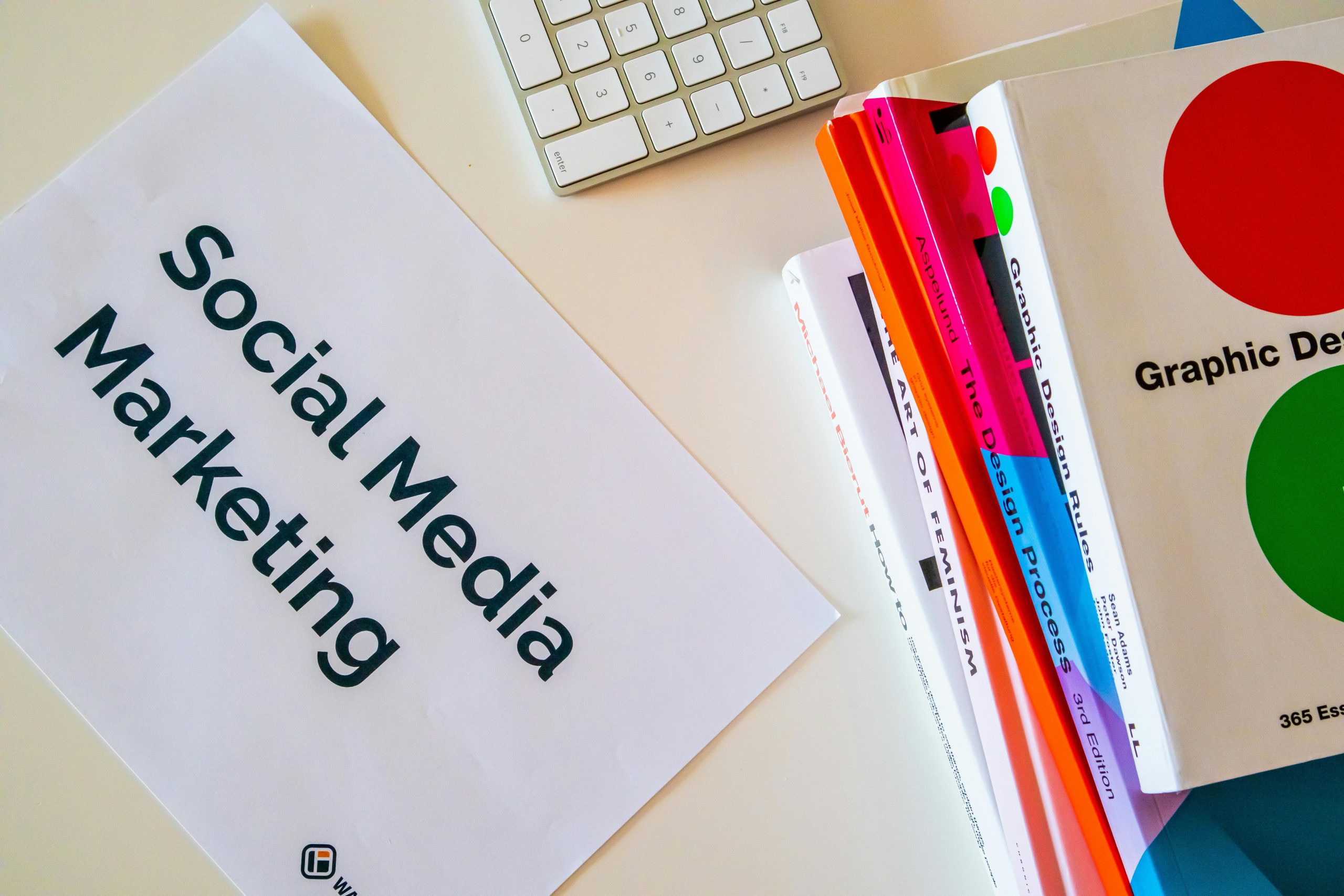 'social media marketing' printed on a piece of paper, next to marketing books